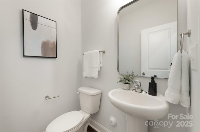 3004 Marlowe Ave, Charlotte, NC 28208 - half bathroom with toilet, baseboards, and a sink