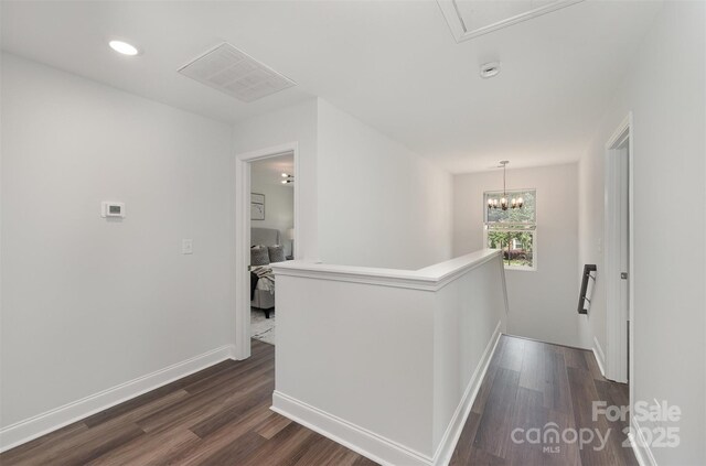 3004 Marlowe Ave, Charlotte, NC 28208 - hallway with an upstairs landing, dark wood-type flooring, baseboards, recessed lighting, and a chandelier