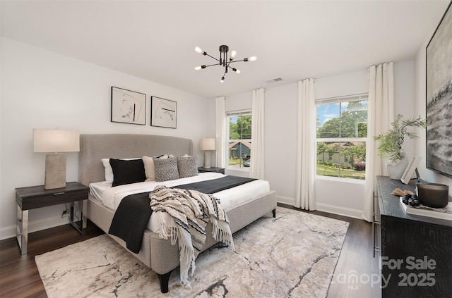 3004 Marlowe Ave, Charlotte, NC 28208 - bedroom featuring a chandelier, dark wood-style floors, and baseboards