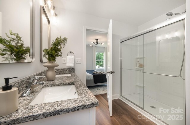 3004 Marlowe Ave, Charlotte, NC 28208 - ensuite bathroom with a stall shower, double vanity, and wood finished floors