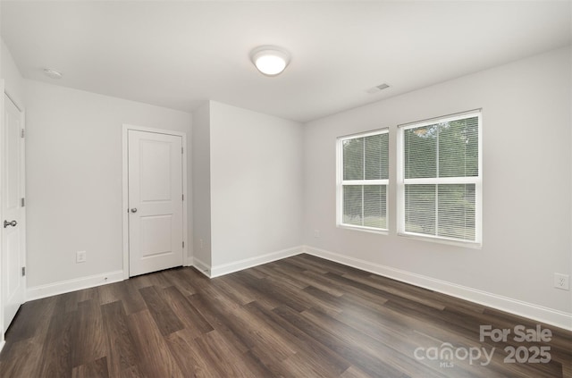 3004 Marlowe Ave, Charlotte, NC 28208 - spare room featuring dark wood finished floors, baseboards, and a smoke detector