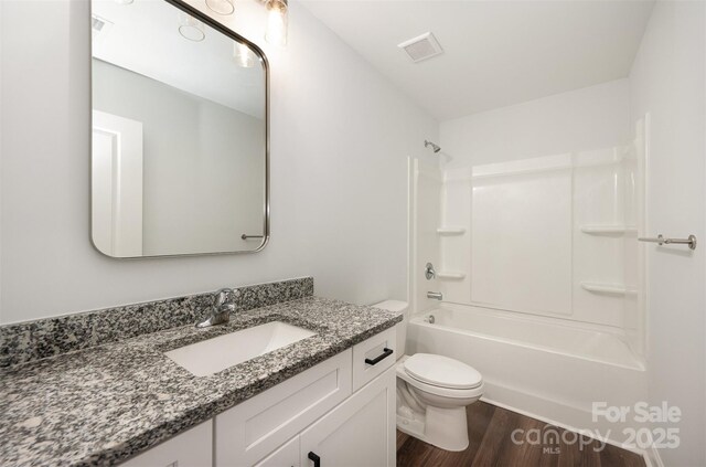 3004 Marlowe Ave, Charlotte, NC 28208 - bathroom featuring wood finished floors, vanity, toilet, and shower / washtub combination