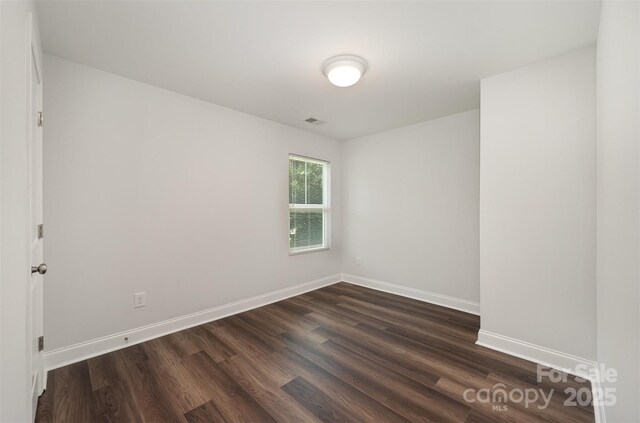 3004 Marlowe Ave, Charlotte, NC 28208 - spare room featuring dark wood-type flooring and baseboards