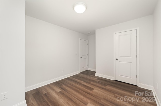 3004 Marlowe Ave, Charlotte, NC 28208 - unfurnished bedroom with dark wood-style flooring and baseboards