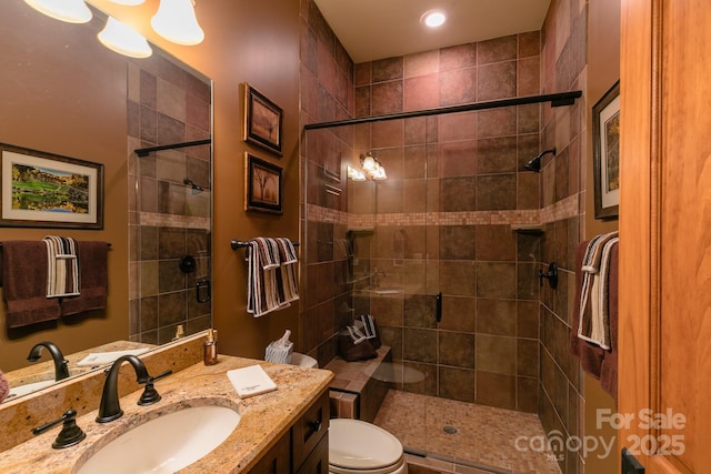 full bath featuring a shower stall, toilet, and vanity