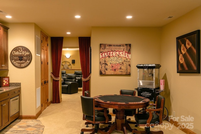 dining room featuring light colored carpet, recessed lighting, and baseboards