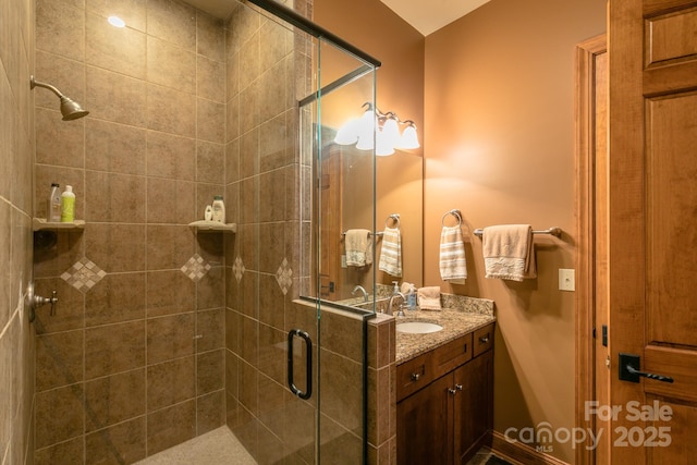full bath featuring a stall shower and vanity