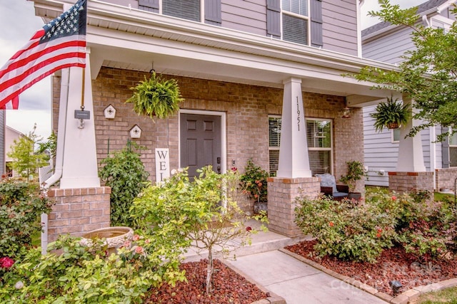 11951 Old Statesville Rd, Huntersville, NC 28078 - view of exterior entry featuring a porch and brick siding