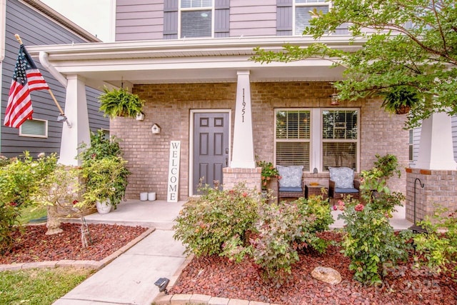 11951 Old Statesville Rd, Huntersville, NC 28078 - property entrance with covered porch and brick siding