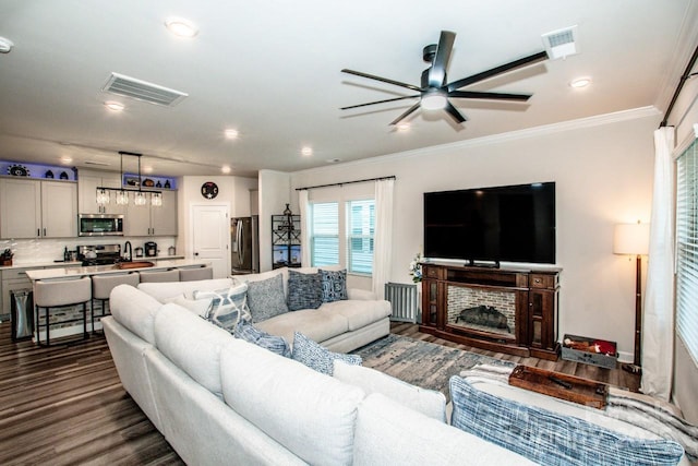 11951 Old Statesville Rd, Huntersville, NC 28078 - living room featuring a ceiling fan, dark wood-style flooring, crown molding, and recessed lighting