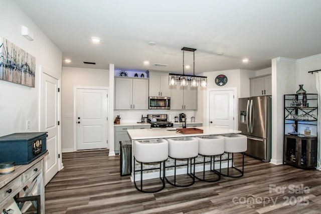 11951 Old Statesville Rd, Huntersville, NC 28078 - kitchen with stainless steel appliances, gray cabinetry, a kitchen bar, recessed lighting, and an island with sink