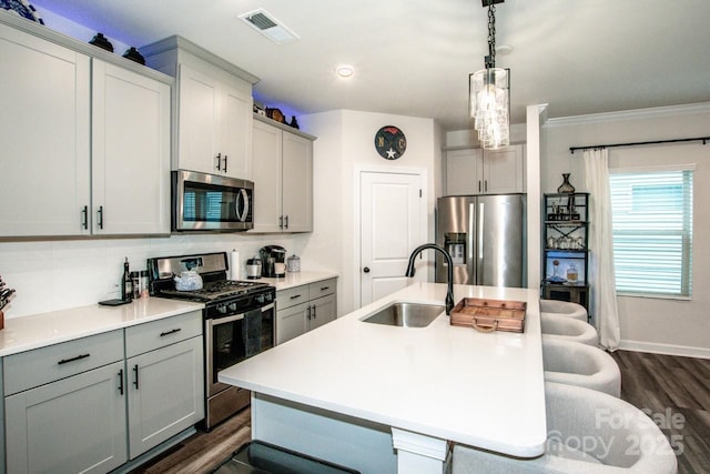 11951 Old Statesville Rd, Huntersville, NC 28078 - kitchen with appliances with stainless steel finishes, a sink, gray cabinets, ornamental molding, and recessed lighting