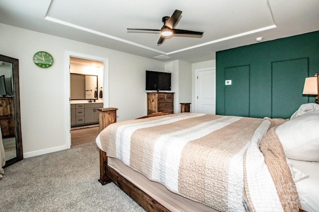 11951 Old Statesville Rd, Huntersville, NC 28078 - carpeted bedroom with a tray ceiling, baseboards, ensuite bath, and ceiling fan