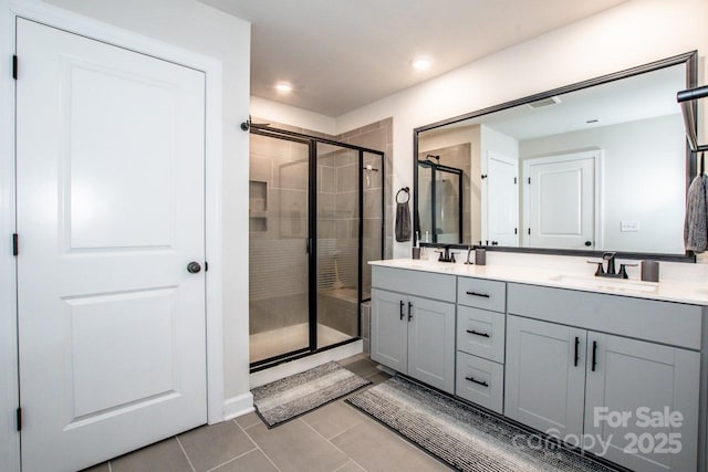 11951 Old Statesville Rd, Huntersville, NC 28078 - bathroom featuring a shower stall, tile patterned floors, double vanity, and recessed lighting