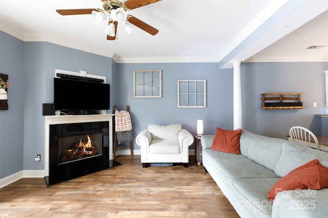 556 Knighton Hill Rd, Rock Hill, SC 29732 - living area featuring wood finished floors, crown molding, a ceiling fan, baseboards, and a lit fireplace