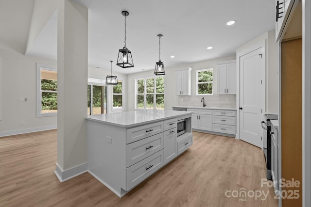4975 Rimer Rd Unit 1, Concord, NC 28025 - kitchen featuring light countertops, light wood-style flooring, white cabinets, and recessed lighting