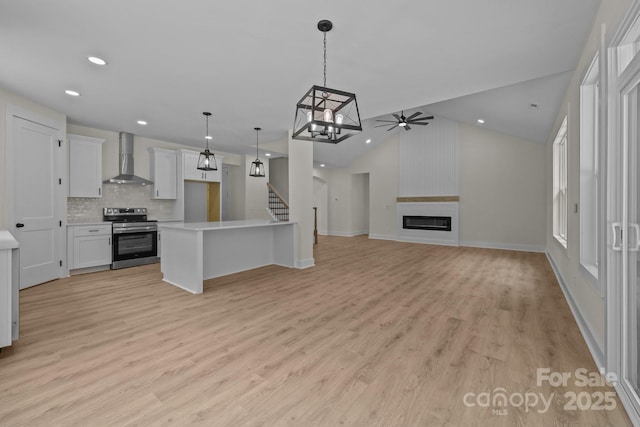 4975 Rimer Rd Unit 1, Concord, NC 28025 - kitchen featuring stainless steel electric range, wall chimney range hood, ceiling fan, light countertops, and recessed lighting