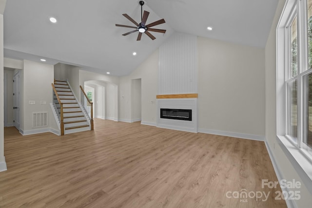 4975 Rimer Rd Unit 1, Concord, NC 28025 - unfurnished living room with stairway, a large fireplace, ceiling fan, high vaulted ceiling, and light wood-style flooring
