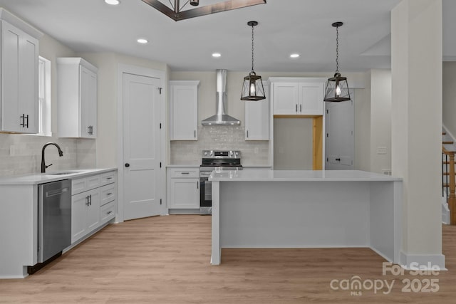4975 Rimer Rd Unit 1, Concord, NC 28025 - kitchen with appliances with stainless steel finishes, wall chimney exhaust hood, light wood finished floors, light countertops, and recessed lighting
