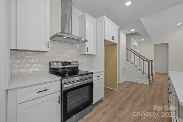 4975 Rimer Rd Unit 1, Concord, NC 28025 - kitchen featuring stainless steel range with electric stovetop, wall chimney exhaust hood, white cabinetry, light countertops, and recessed lighting