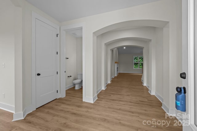 4975 Rimer Rd Unit 1, Concord, NC 28025 - hallway with arched walkways and light wood-type flooring