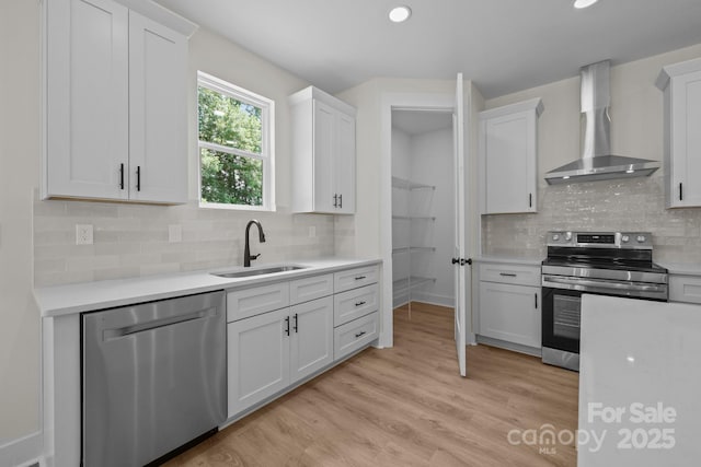 4975 Rimer Rd Unit 1, Concord, NC 28025 - kitchen with appliances with stainless steel finishes, wall chimney range hood, light countertops, white cabinetry, and recessed lighting
