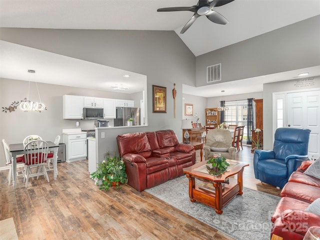 379 Running Briar Rd, Fletcher, NC 28732 - living room featuring light wood finished floors, a ceiling fan, high vaulted ceiling, and a chandelier
