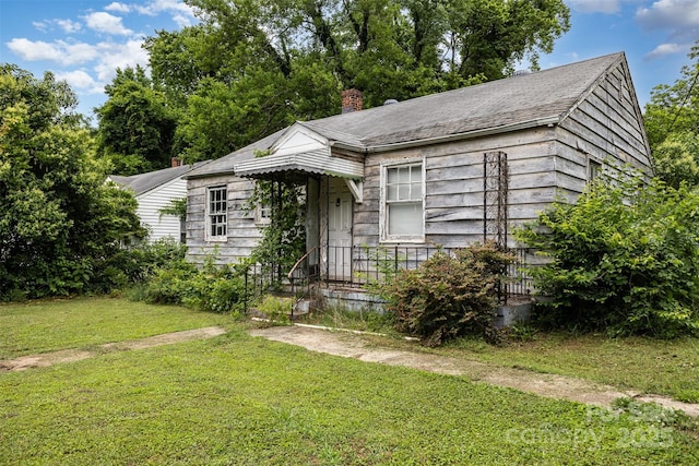 2308 Vanderbilt Rd, Charlotte, NC 28206 - view of front of home with a front yard and a chimney