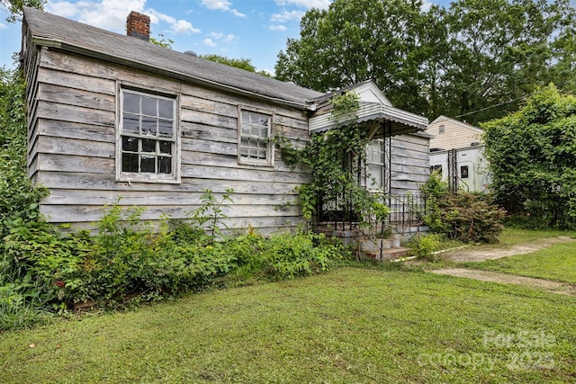 2308 Vanderbilt Rd, Charlotte, NC 28206 - view of home's exterior with a lawn and a chimney