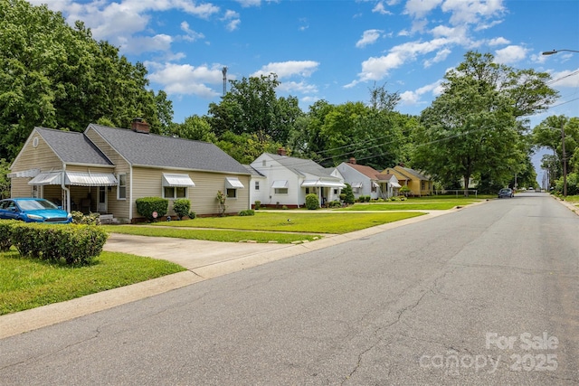 2308 Vanderbilt Rd, Charlotte, NC 28206 - view of front facade with a front yard, a residential view, and a chimney