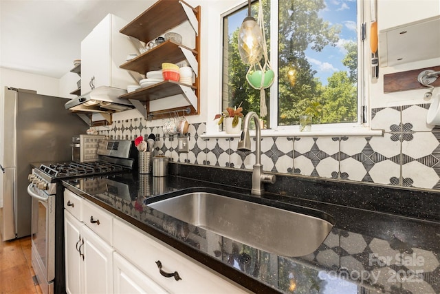 7015 Lavern St, Charlotte, NC 28215 - kitchen with stainless steel gas range, under cabinet range hood, open shelves, and tasteful backsplash