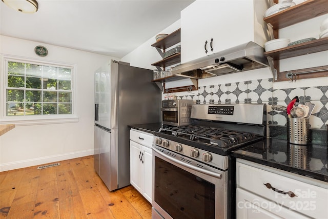 7015 Lavern St, Charlotte, NC 28215 - kitchen featuring appliances with stainless steel finishes, open shelves, under cabinet range hood, backsplash, and white cabinetry