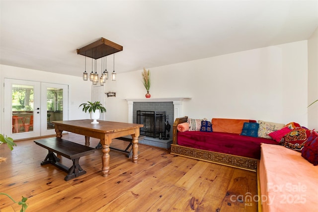7015 Lavern St, Charlotte, NC 28215 - living room featuring french doors, light wood-style floors, and a fireplace