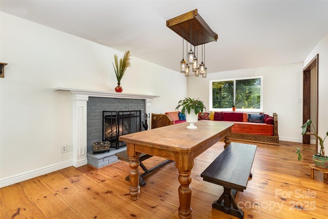 7015 Lavern St, Charlotte, NC 28215 - dining space with light wood-style flooring and a fireplace