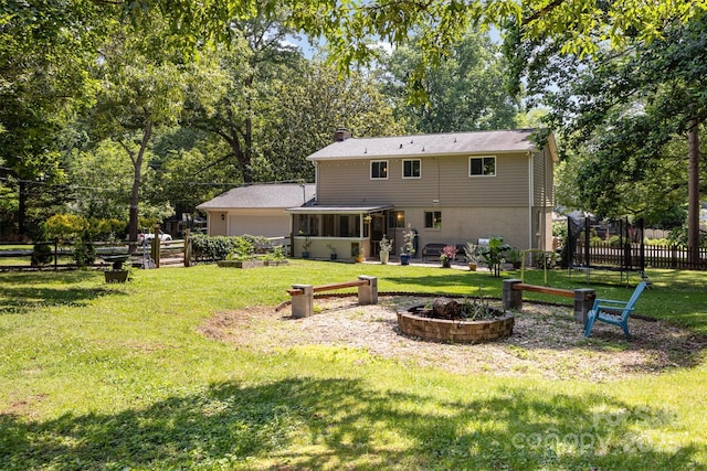 7015 Lavern St, Charlotte, NC 28215 - back of house featuring a garage, a sunroom, a chimney, and view of wooded area