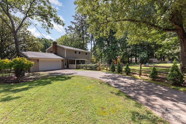 7015 Lavern St, Charlotte, NC 28215 - view of front of house with driveway, a chimney, and an attached garage