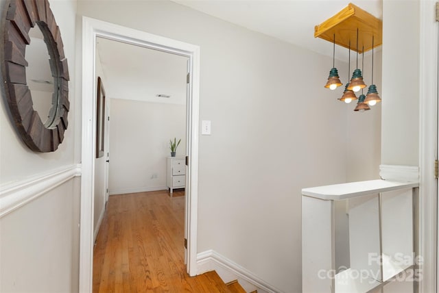 7015 Lavern St, Charlotte, NC 28215 - hall featuring light wood-style floors, a chandelier, and an upstairs landing