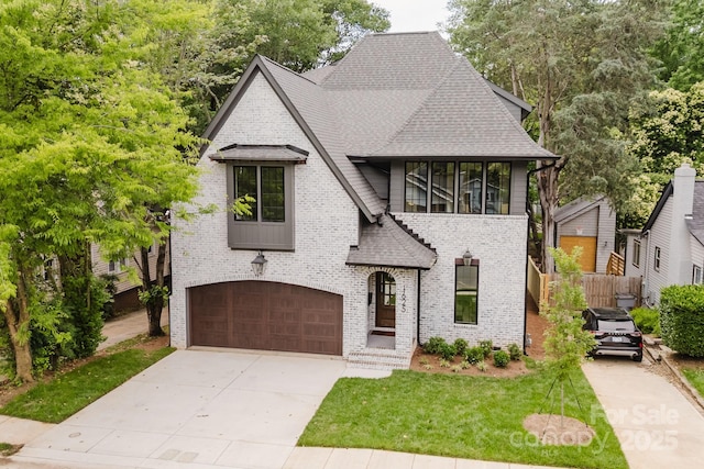 1625 Club Rd, Charlotte, NC 28205 - french country home with roof with shingles, an attached garage, brick siding, and driveway