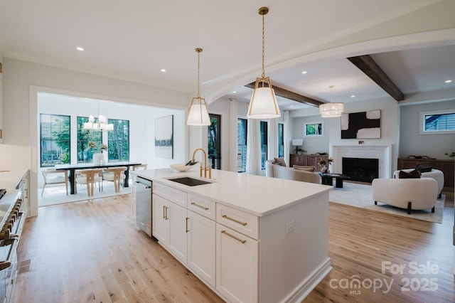 1625 Club Rd, Charlotte, NC 28205 - kitchen featuring light wood-style flooring, beam ceiling, white cabinetry, healthy amount of natural light, and hanging light fixtures