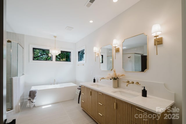 1625 Club Rd, Charlotte, NC 28205 - full bathroom with a soaking tub, double vanity, a stall shower, a chandelier, and tile patterned flooring