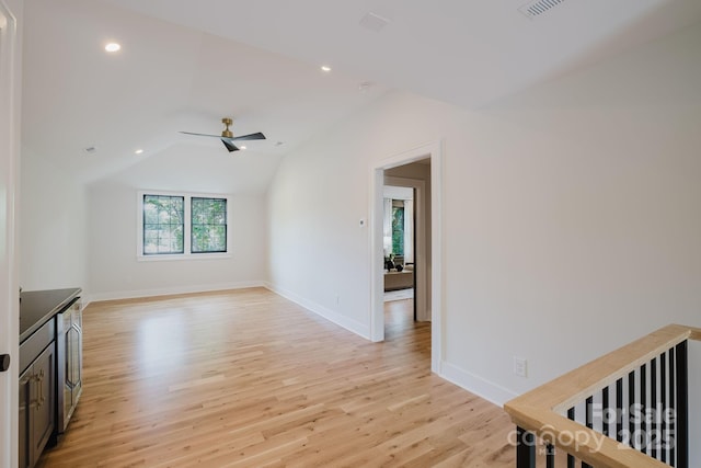 1625 Club Rd, Charlotte, NC 28205 - unfurnished living room with light wood-style flooring, ceiling fan, vaulted ceiling, recessed lighting, and beverage cooler