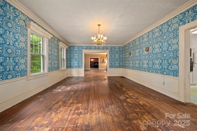 93 Villa Barbara Ln, Tryon, NC 28782 - unfurnished dining area featuring wood-type flooring, a chandelier, crown molding, wainscoting, and wallpapered walls