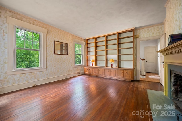 93 Villa Barbara Ln, Tryon, NC 28782 - unfurnished living room with wallpapered walls, dark wood-style floors, a fireplace with flush hearth, baseboards, and ornamental molding