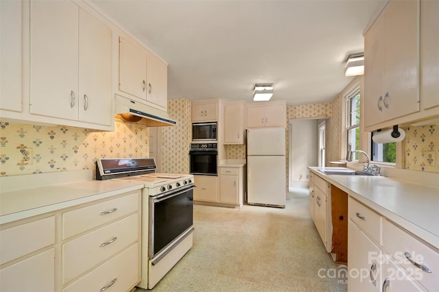 93 Villa Barbara Ln, Tryon, NC 28782 - kitchen featuring white appliances, under cabinet range hood, a sink, wallpapered walls, and light countertops