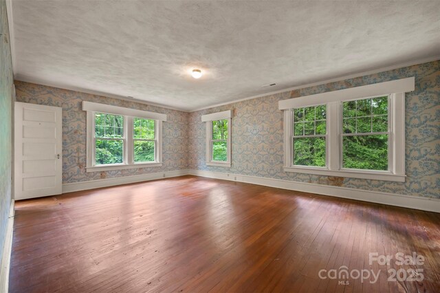 93 Villa Barbara Ln, Tryon, NC 28782 - spare room featuring wallpapered walls, hardwood / wood-style flooring, and baseboards
