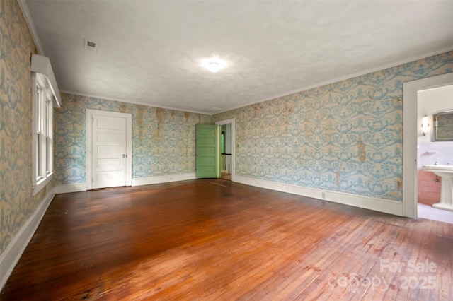 93 Villa Barbara Ln, Tryon, NC 28782 - unfurnished room featuring dark wood-style floors, wallpapered walls, crown molding, and baseboards