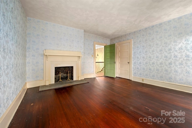 93 Villa Barbara Ln, Tryon, NC 28782 - unfurnished living room with wallpapered walls, wood-type flooring, and a fireplace