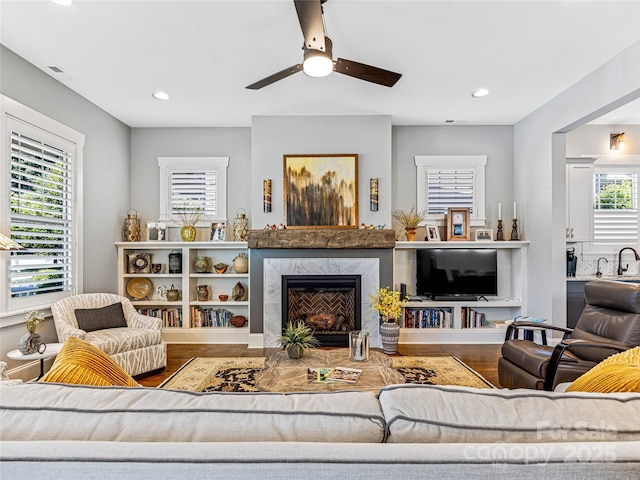 294 W Main St, Brevard, NC 28712 - living area featuring wood finished floors, a ceiling fan, a high end fireplace, and recessed lighting