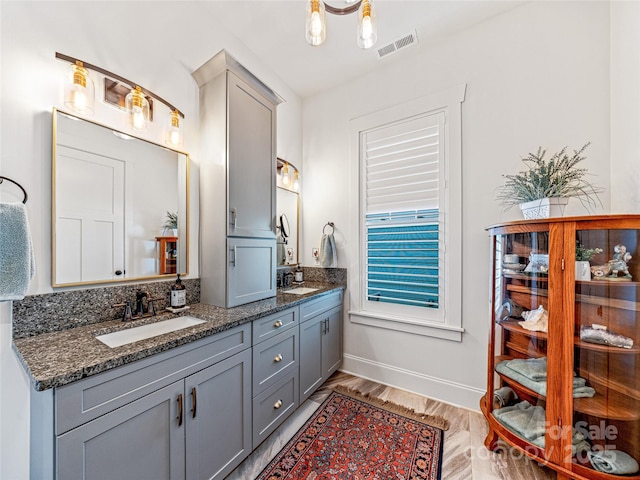 294 W Main St, Brevard, NC 28712 - bathroom featuring double vanity, baseboards, and wood finished floors