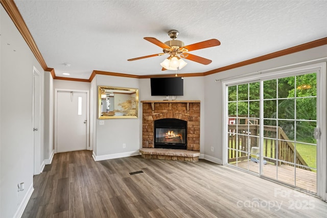 2021 Beamguard Rd, Clover, SC 29710 - unfurnished living room with baseboards, wood finished floors, ceiling fan, a stone fireplace, and crown molding